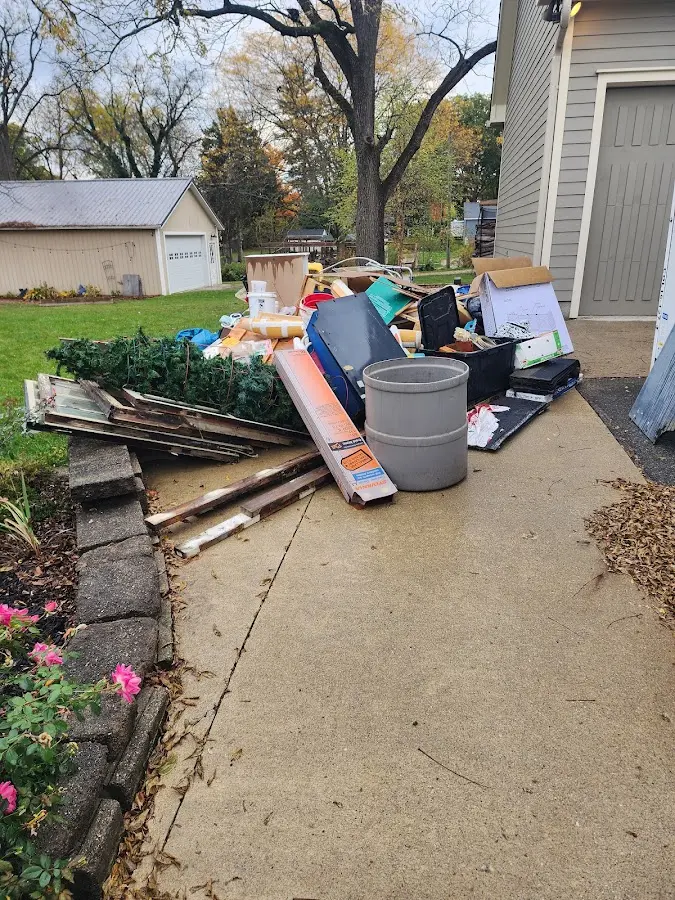 Dumpster being loaded with debris for 12 Yard Dumpster Rental in Fowler